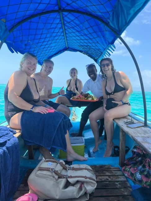 FROM KENDWA; Mnemba snorkelling and Dolphin tour - Fruit, water, and a simple onboard break
