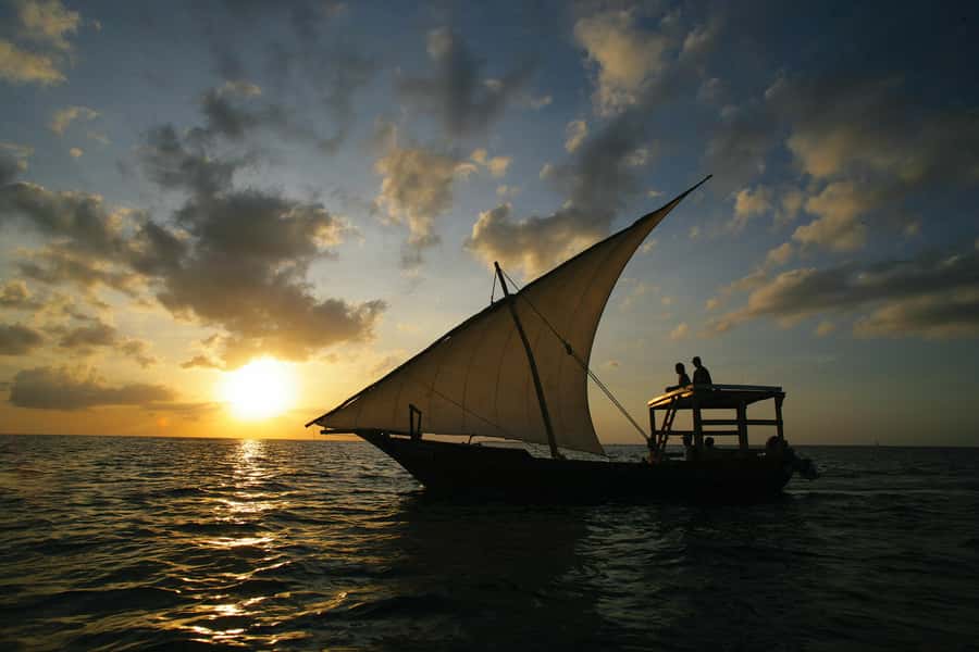 Stone Town: Traditional Dhow Sunset Cruise - A traditional dhow on calm coastal water